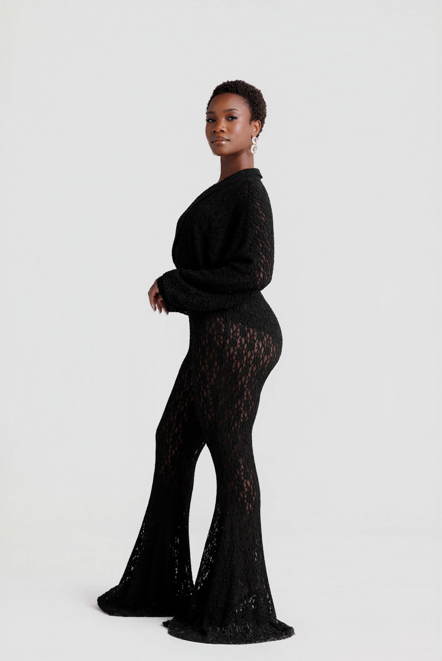 woman wearing a black lace outfit on a white background