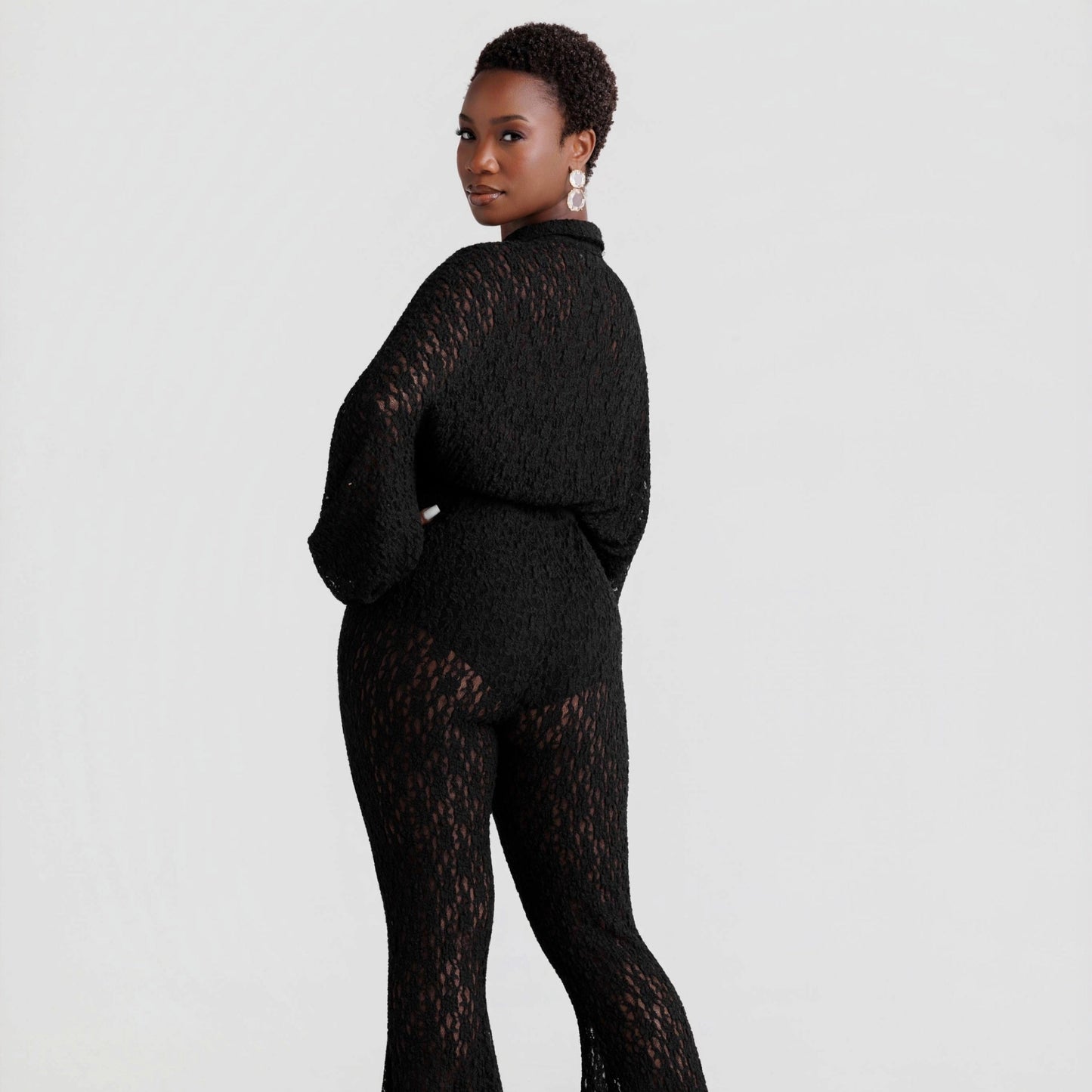 woman wearing a black lace outfit on a white background