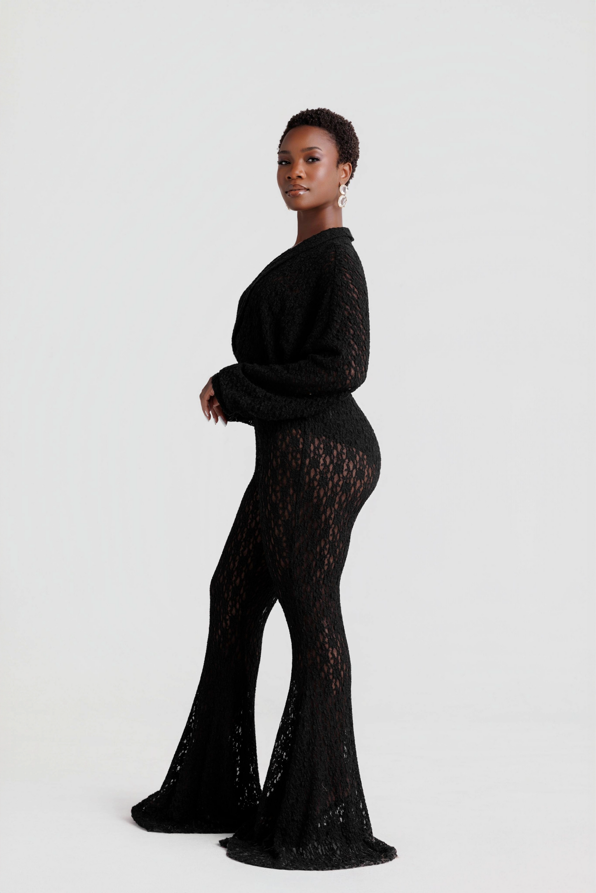 woman wearing a black lace outfit on a white background